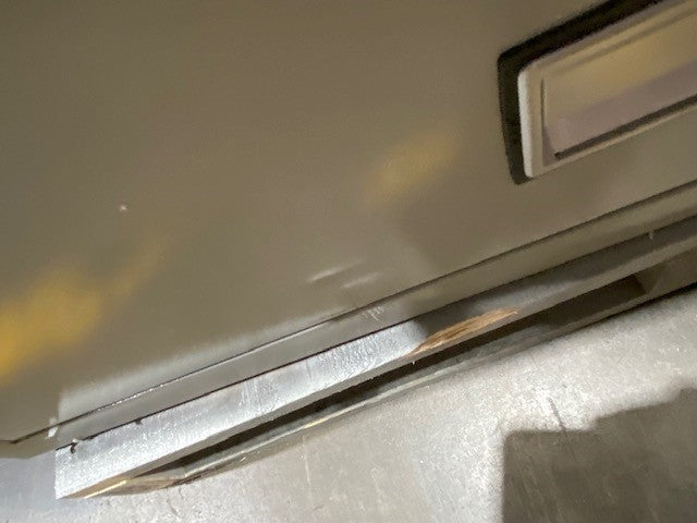 Dent on bottom drawer and scratch on front below bottom drawer